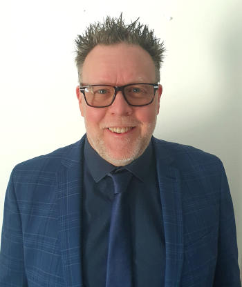 Photograph
    of Jonathan Gibbs in a blue suit